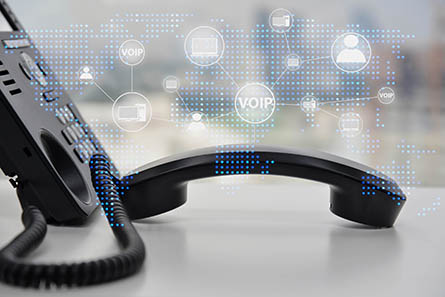 IP Phone double exposure with blue LED world map and business icon